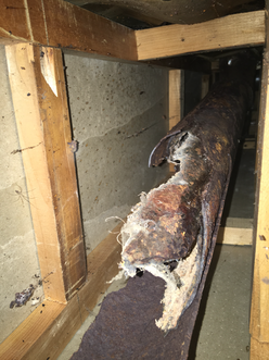 Broken cast iron drain pipe in a basement 